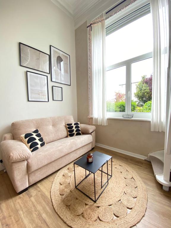 un salon avec un canapé et une table dans l'établissement Duplex au centre de Wimereux et proche de la mer, à Wimereux