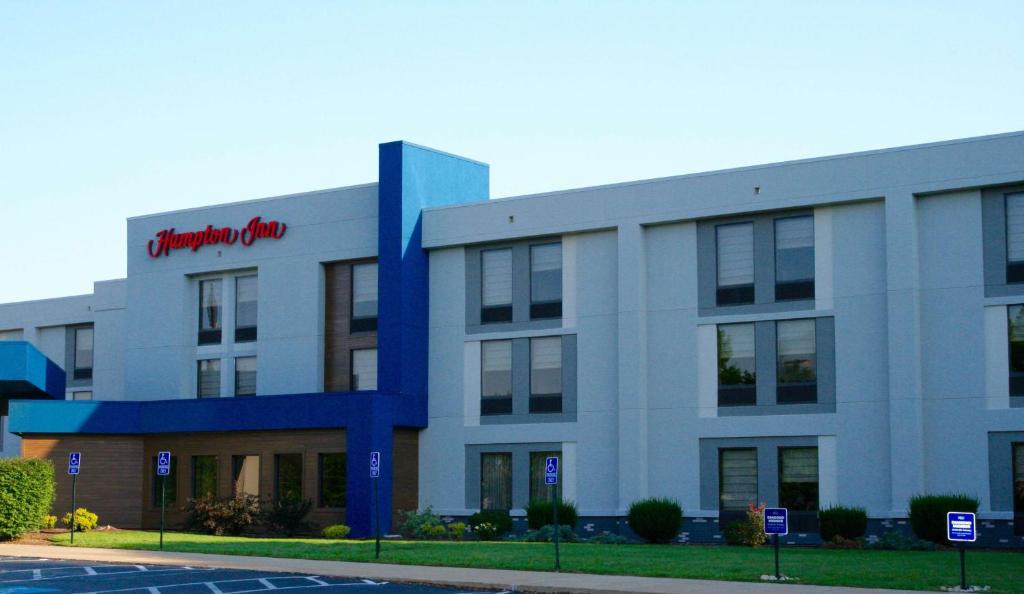 a building with a red sign on the side of it at Hampton Inn DuBois in DuBois
