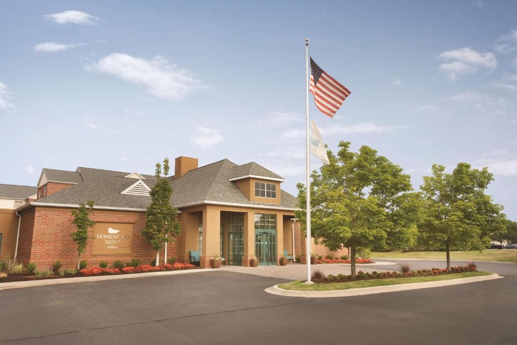 a building with an american flag in front of it at Homewood Suites by Hilton Detroit-Troy in Birmingham