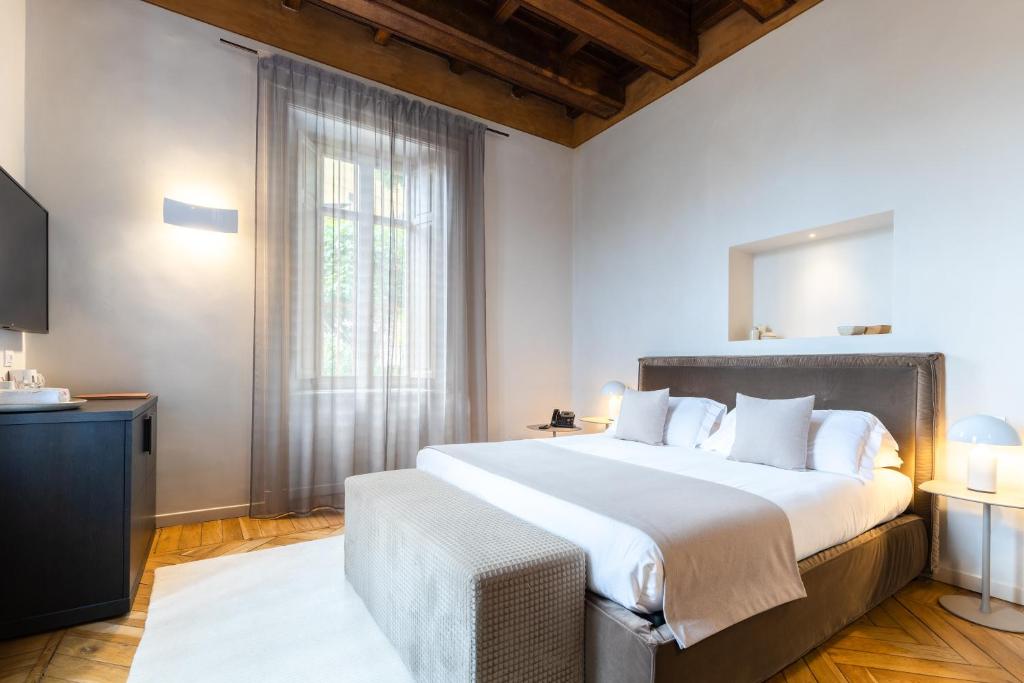 Postel nebo postele na pokoji v ubytování Relais Villa del Borgo