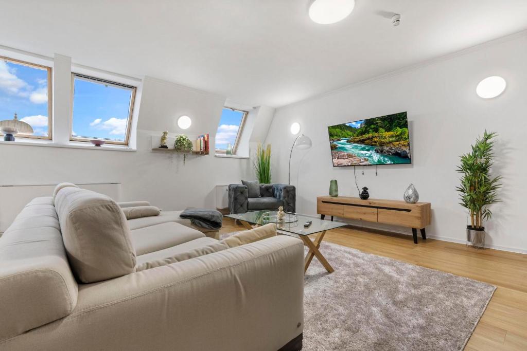 a living room with a couch and a table at Family Hub in Centre in Bratislava