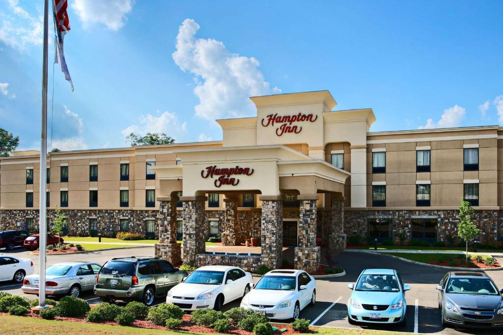 a hotel with cars parked in front of it at Hampton Inn Enterprise in Enterprise