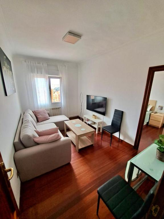 a living room with a couch and a table at Apartamento luminoso Santander in Santander