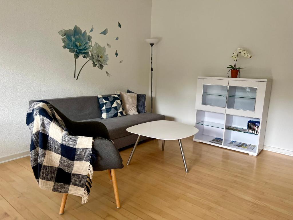 a living room with a couch and a table at Stor 2 værelses lejlighed in Randers