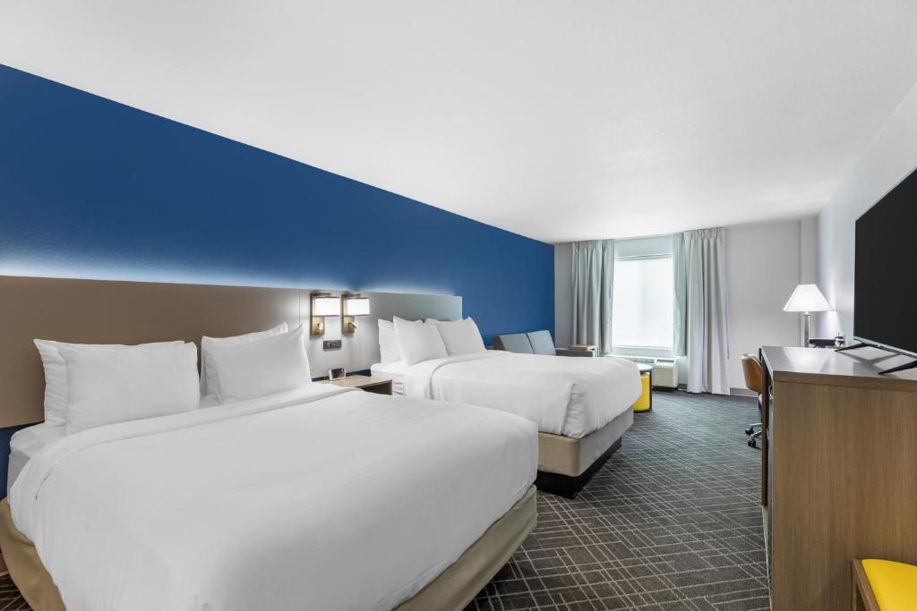 a hotel room with two beds and a desk at Comfort Inn & Suites Glenwood Springs On The River in Glenwood Springs