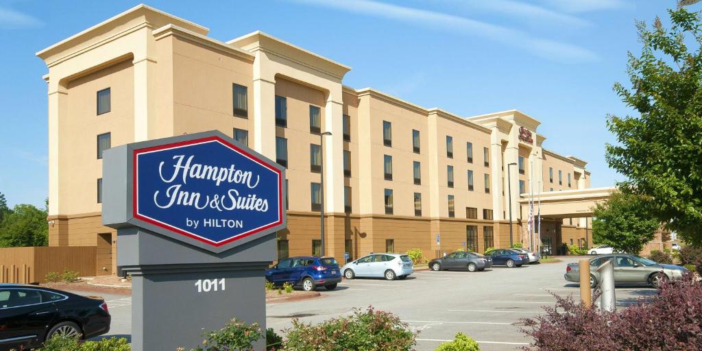 a sign for a shopping center in a parking lot at Hampton Inn & Suites Seneca-Clemson Area in Seneca