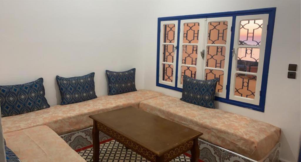 a living room with a couch and a table at Inviting 1-Bed Apartment in Ksar sghir in Ksar es Sghir