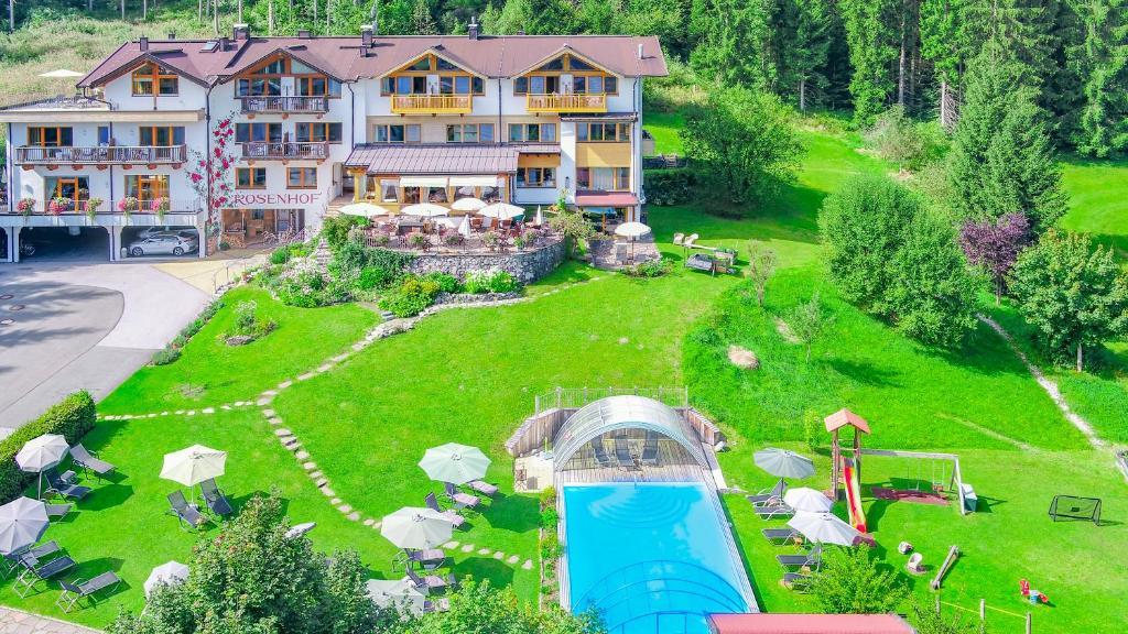 an aerial view of a large house with a swimming pool at Gartenhotel Rosenhof bei Kitzbühel in Oberndorf in Tirol