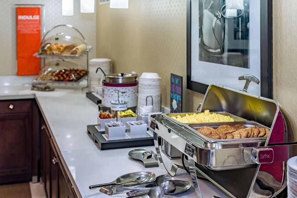 a kitchen counter with a buffet of food on it at Hampton Inn Niagara Falls/ Blvd in Niagara Falls