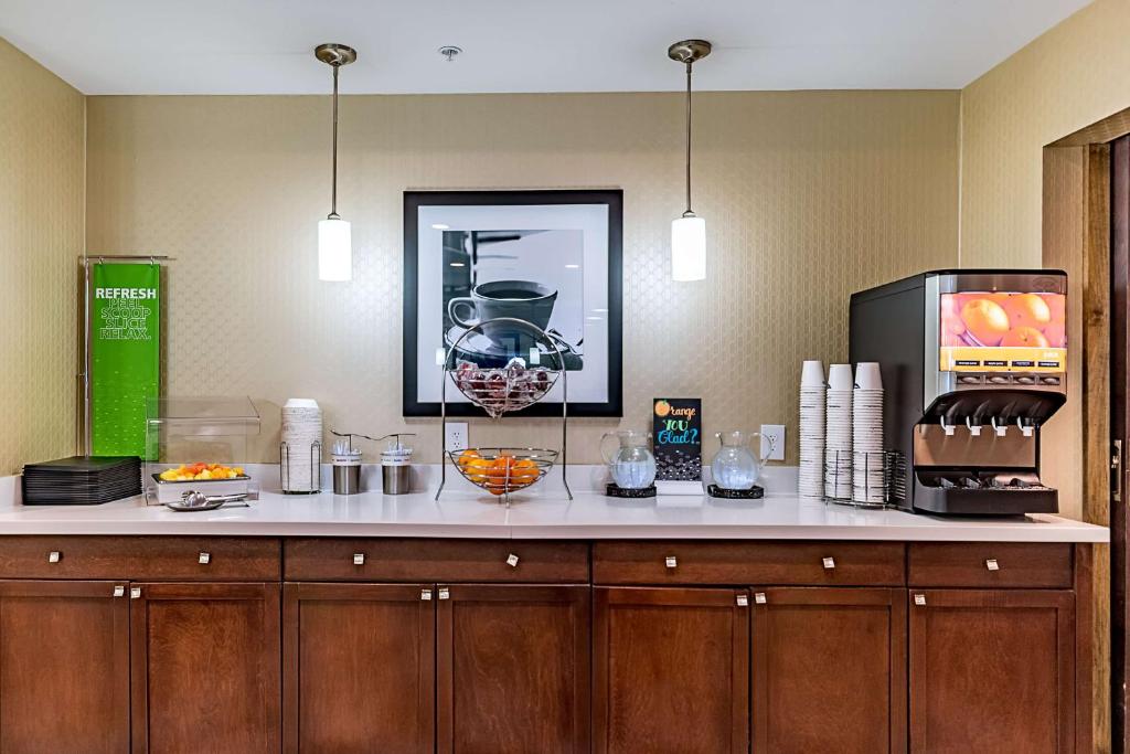 a kitchen with a counter with food and a microwave at Hampton Inn Niagara Falls/ Blvd in Niagara Falls