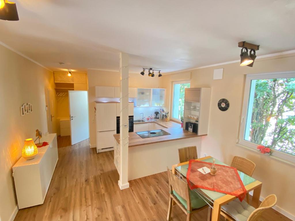 a kitchen and a dining room with a table and a kitchen at Apartment am Schloss in Brühl