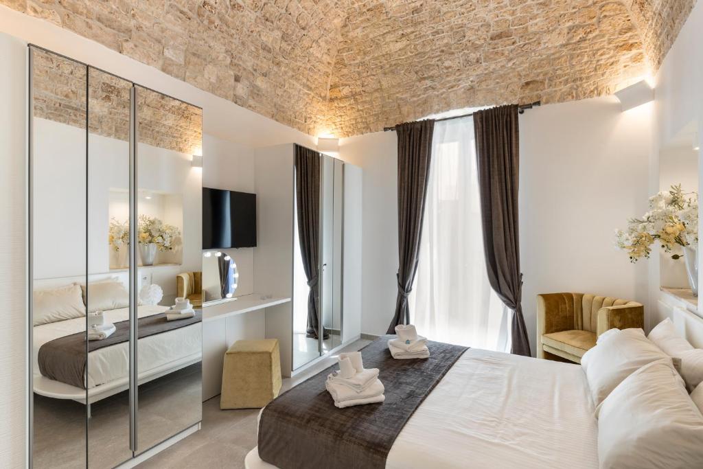 a hotel room with a bed and a couch at Casa Massima Suites & SPA in Casamassima