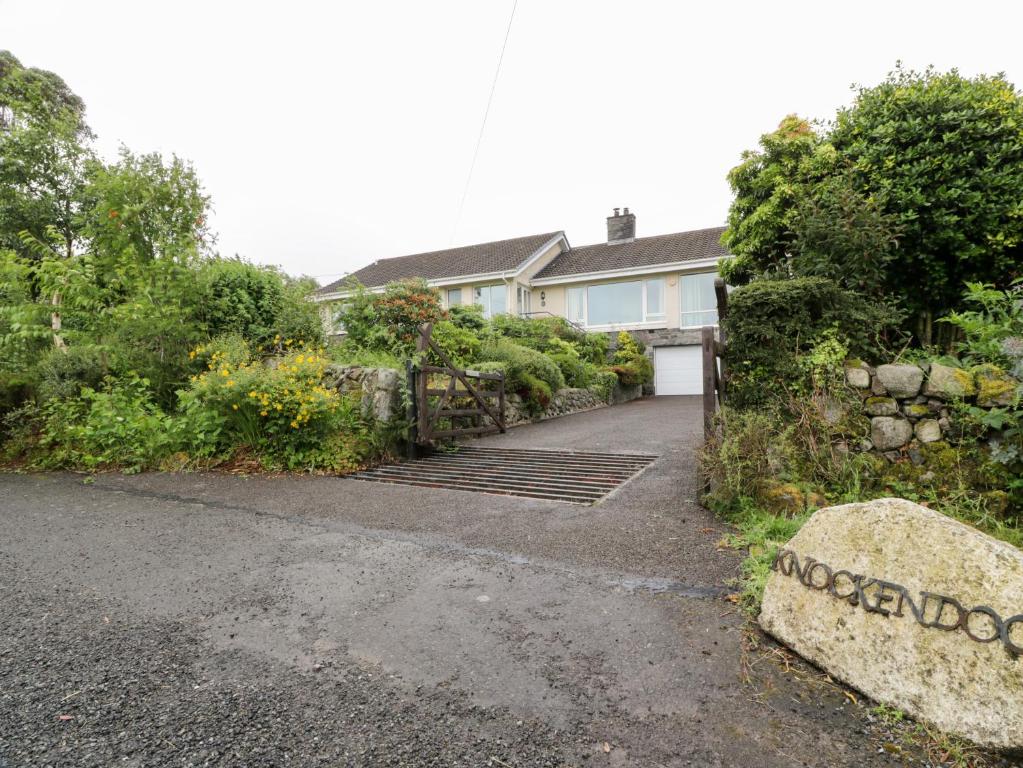 a house with a gate and a driveway at Knockendoch in Dumfries