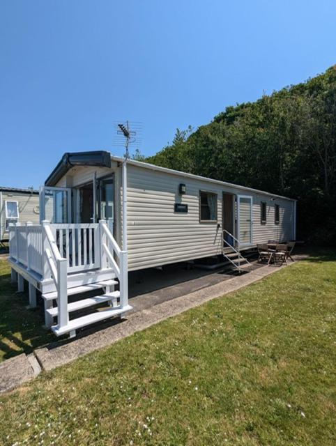 a mobile home with a porch and a deck at Littlesea Caravan on a Fabulous elevated position Haven Weymouth in Weymouth