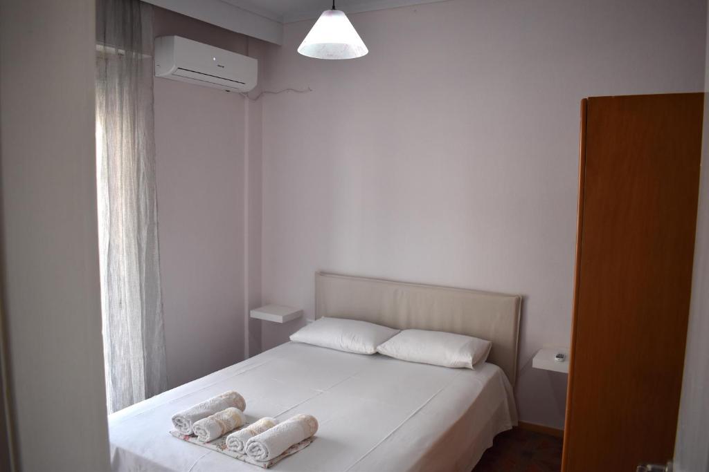 a bedroom with a bed with two towels on it at Giorgos house in Nea Kalikratia