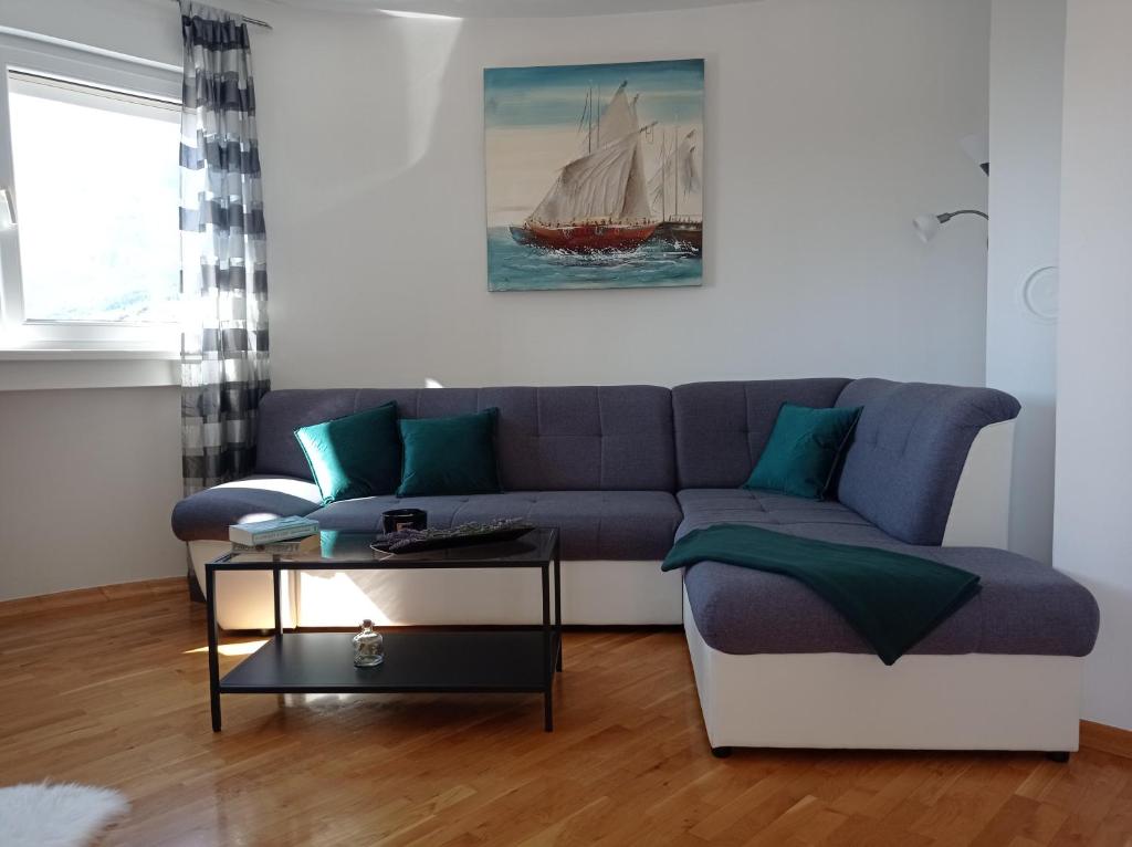 a living room with a couch and a table at City Apartment Dora in Makarska