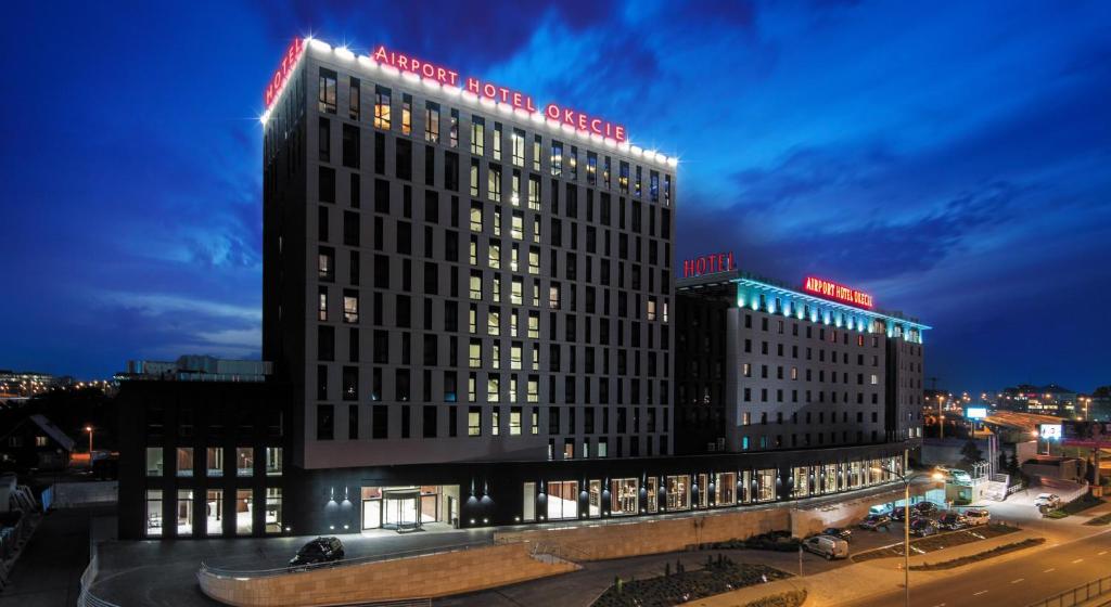 a large building with lights on top of it at night at Airport Hotel Okęcie in Warsaw