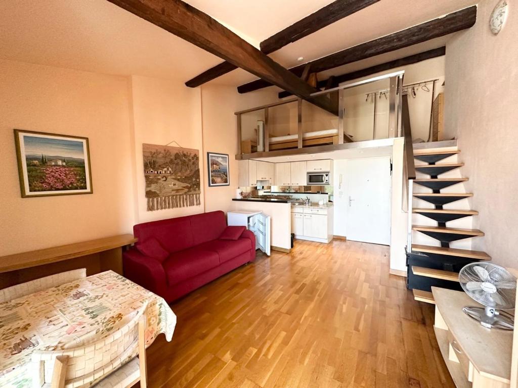 un salon avec un canapé rouge et une cuisine dans l'établissement Résidence 3 Massena, à Nice