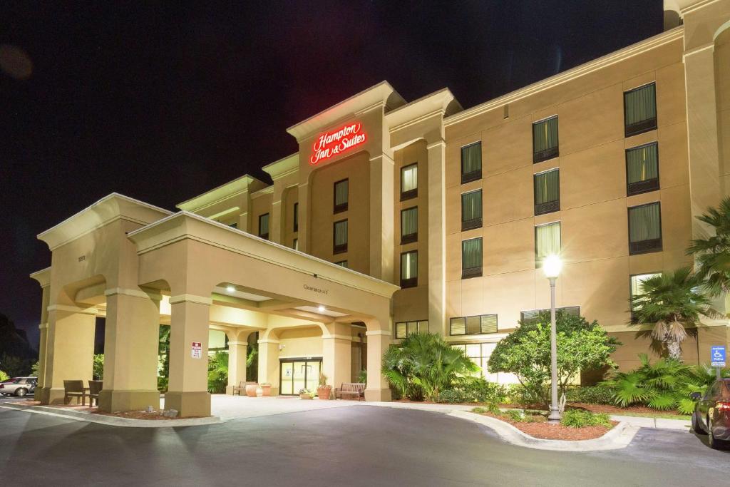 a hotel with a sign on the front of it at Hampton Inn & Suites Jacksonville-Airport in Jacksonville