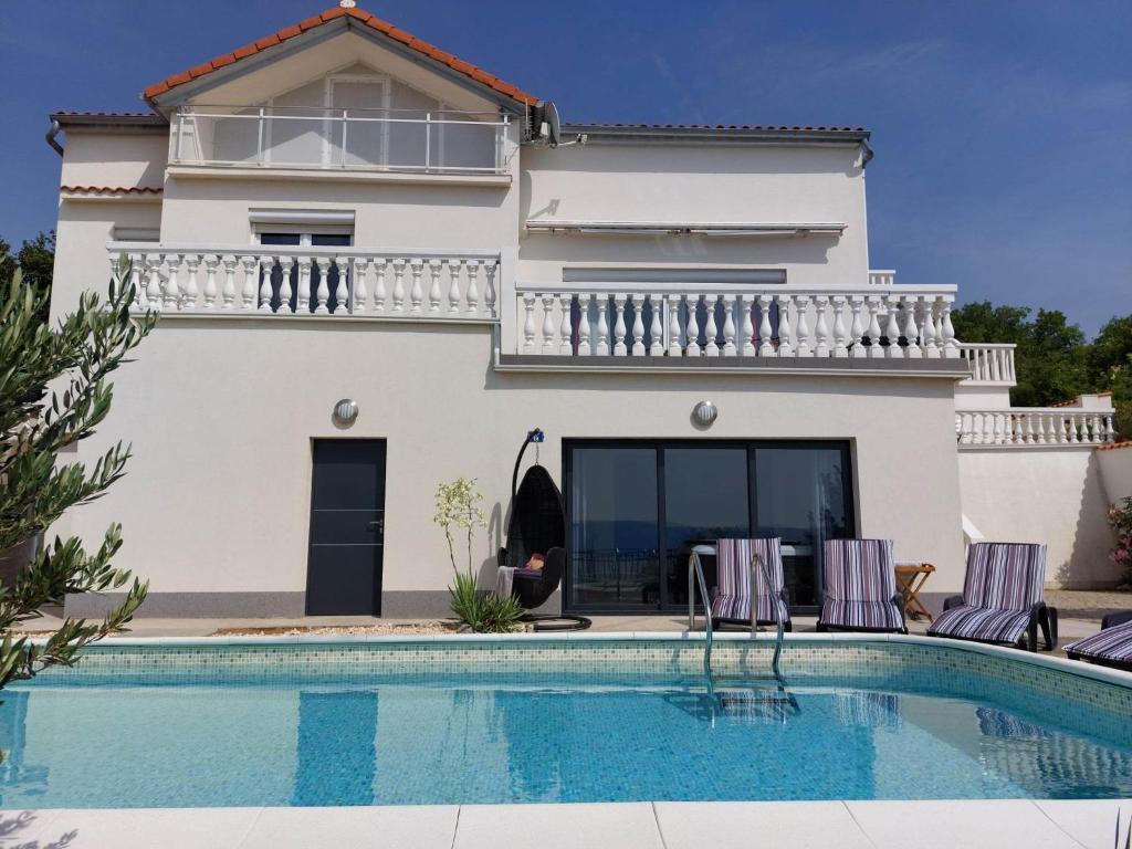 een villa met een zwembad voor een huis bij Villa Panoramic view in Senj