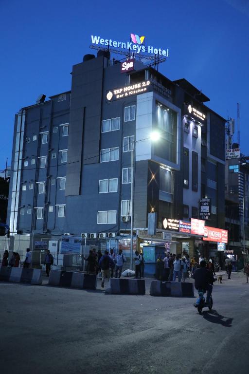 a building with a sign on top of it at Western Keys Hotel in Bangalore