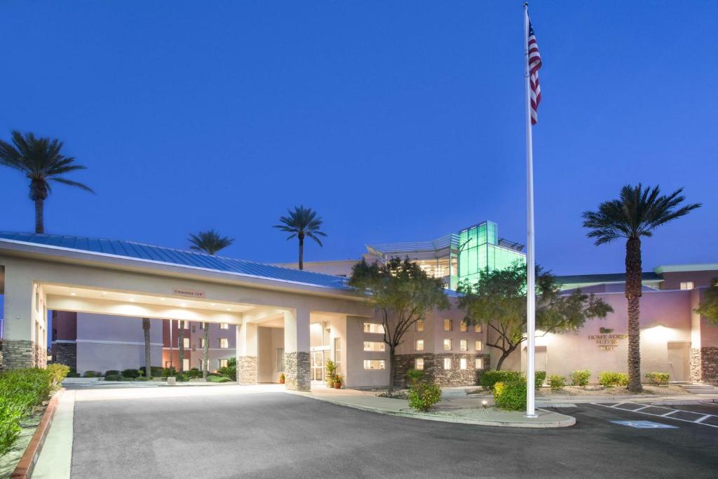 a hotel with a flag in front of a parking lot at Homewood Suites by Hilton South Las Vegas in Las Vegas