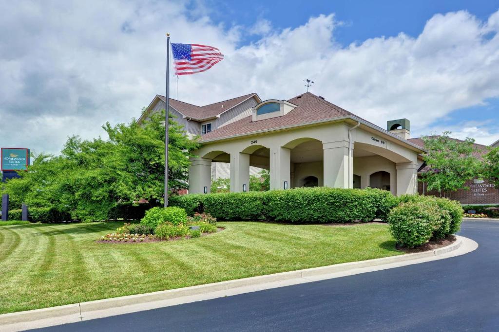 a house with an american flag in the yard at Homewood Suites by Hilton Lexington Fayette Mall in Lexington