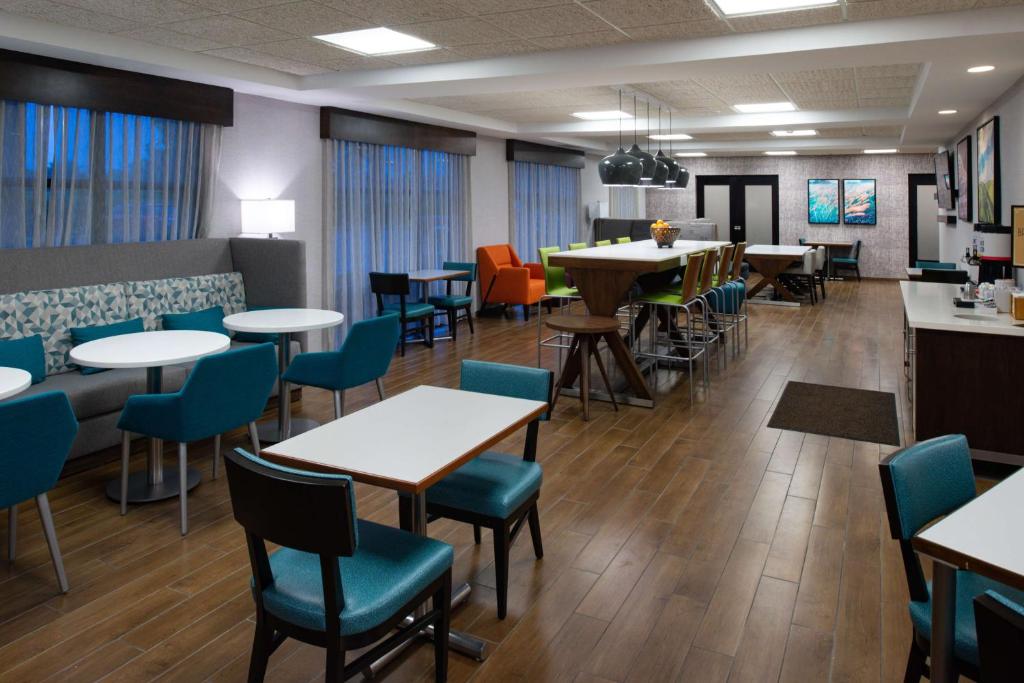 a dining room with tables and chairs at Hampton Inn LaPorte in LaPorte