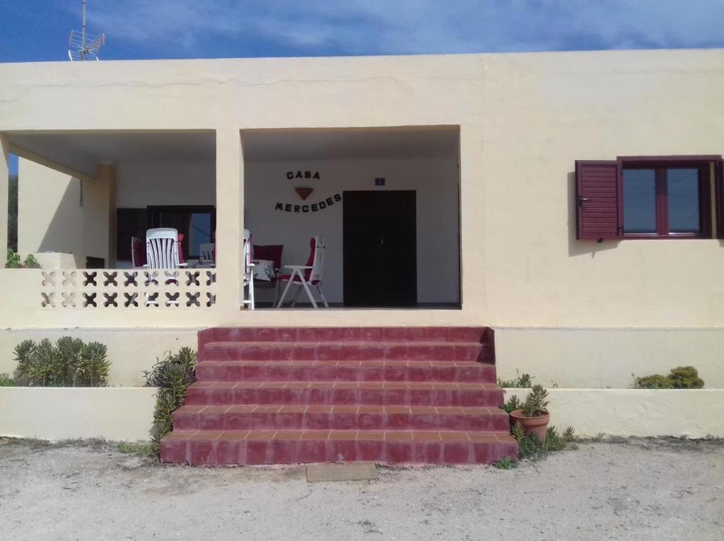 a house with stairs leading to the front door at Casa Mercedes in San Ferrán de ses Roques