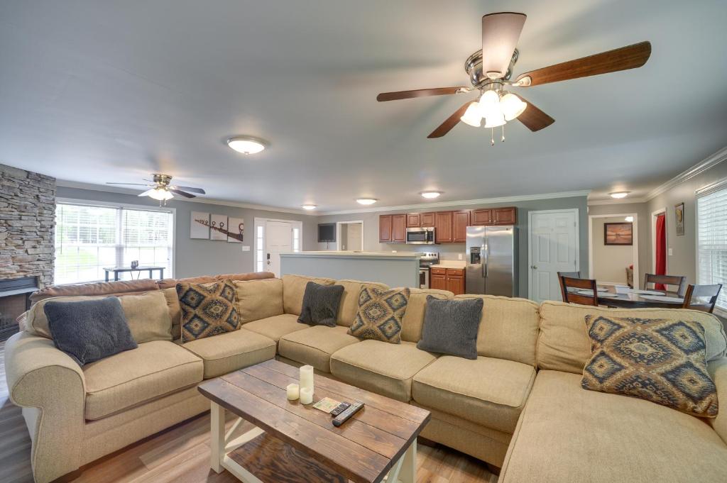 a living room with a couch and a ceiling fan at Guntersville Lake House Dock and Boat Ramp Access! in Scottsboro