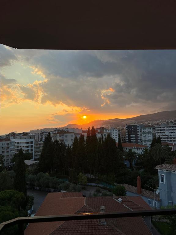a sunset from the balcony of a city at Lüks manzaralı daire in Burunabat
