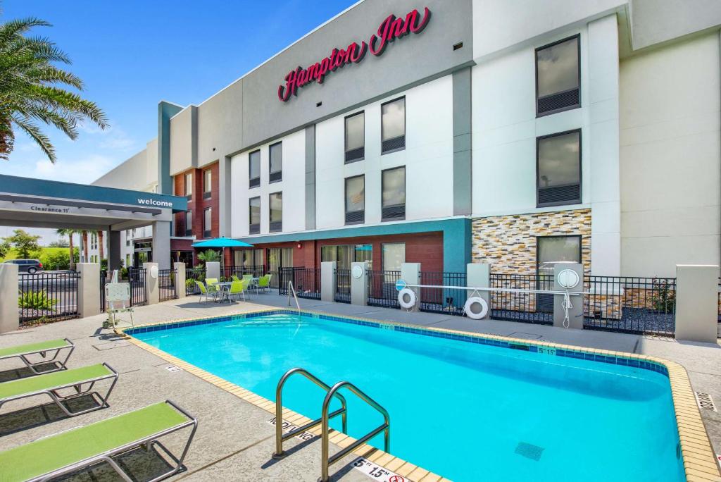 a swimming pool in front of a hotel at Hampton Inn Slidell in Slidell