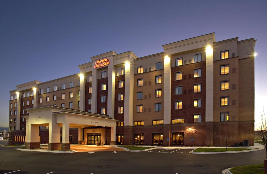 a hotel building with a parking lot in front of it at Hampton Inn & Suites Minneapolis St. Paul Airport - Mall of America in Bloomington