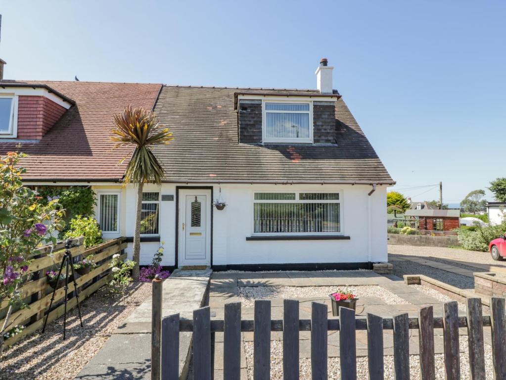 a house with a fence in front of it at 22 Turnberry Road in Girvan