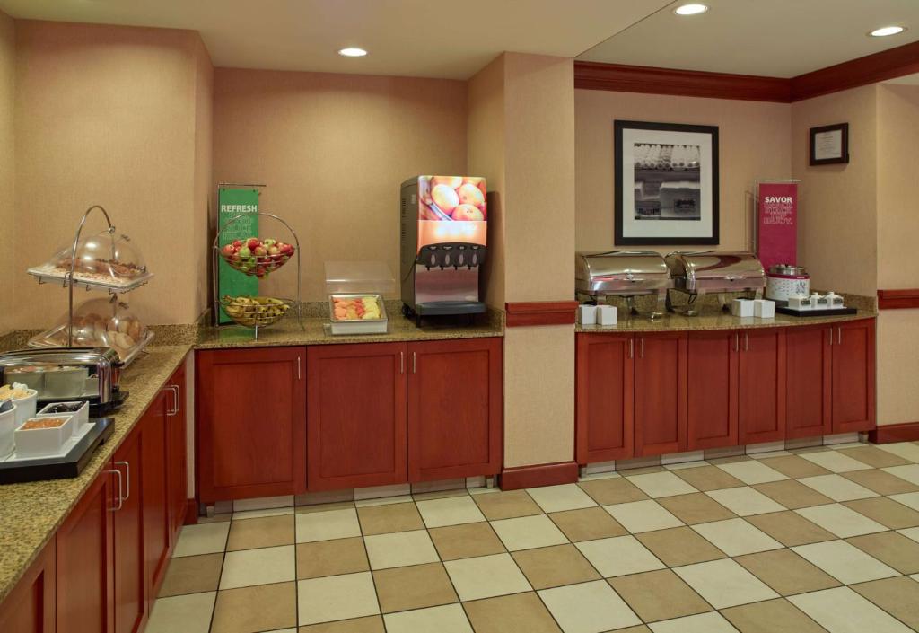 a restaurant kitchen with red cabinets and a counter at Hampton Inn & Suites North Conway in North Conway
