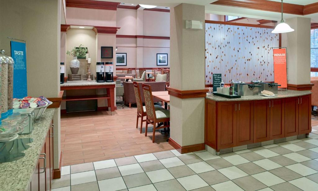 a lobby of a restaurant with a counter and chairs at Hampton Inn & Suites North Conway in North Conway
