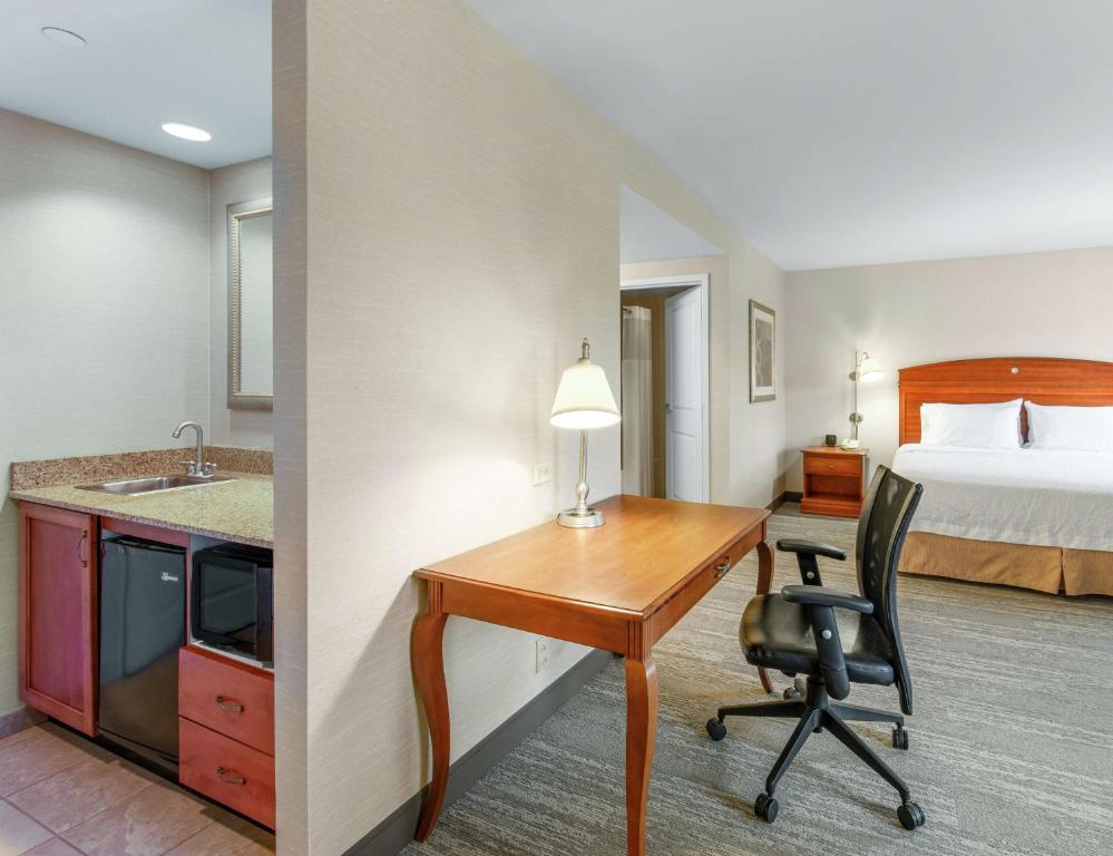 a hotel room with a desk and a bed at Hampton Inn & Suites North Conway in North Conway