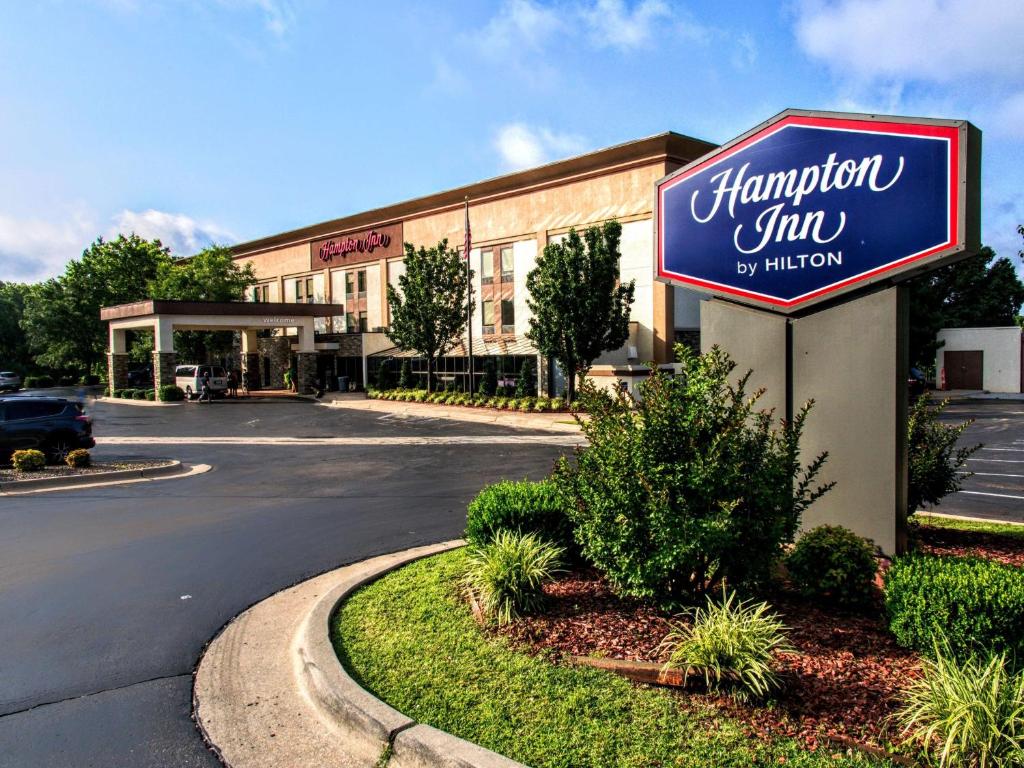 a hampton inn sign in front of a building at Hampton Inn Edmond in Edmond