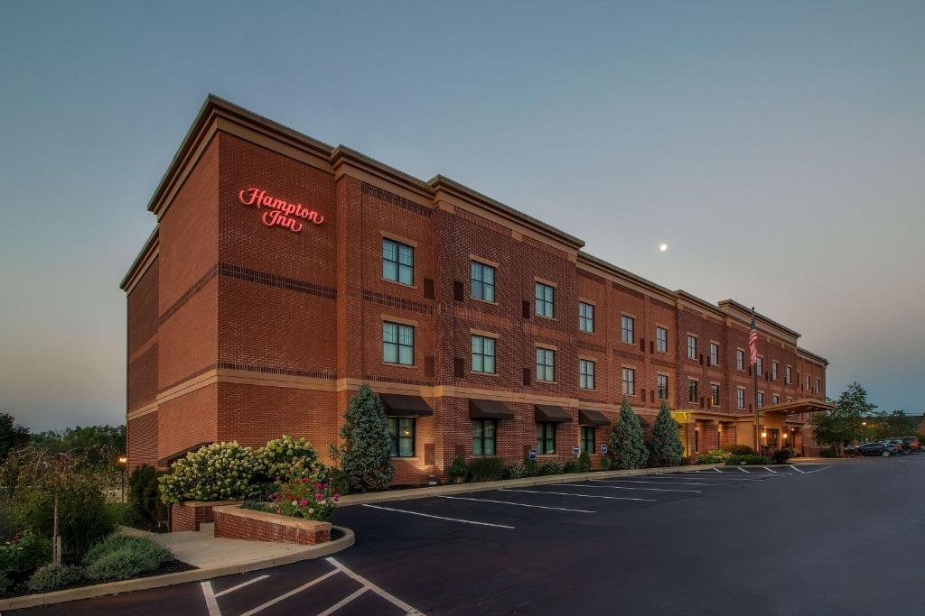 a large red brick building with a sign on it at Hampton Inn Oxford/Miami University Area in Oxford