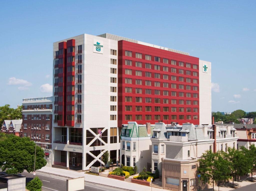 a tall red and white building in a city at Homewood Suites University City Philadelphia in Philadelphia