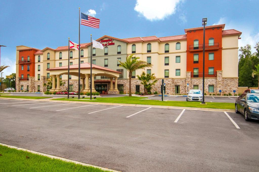 a hotel with a car parked in a parking lot at Hampton Inn & Suites Pensacola/I-10 Pine Forest Road in Pensacola