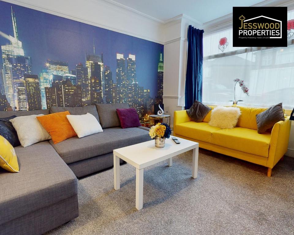 a living room with a couch and a table at Stylish 3 Bedroom House by Jesswood Properties Short Lets near M1 Luton Airport For Contractors & Business in Luton
