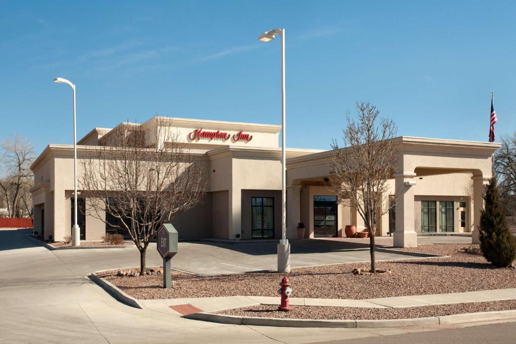 a building with a fire hydrant in front of it at Hampton Inn Canon City in Canon City