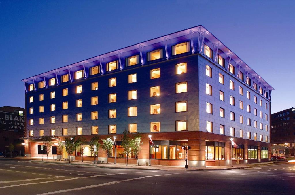 a large building on a city street at night at Hilton Garden Inn Portland Downtown Waterfront in Portland