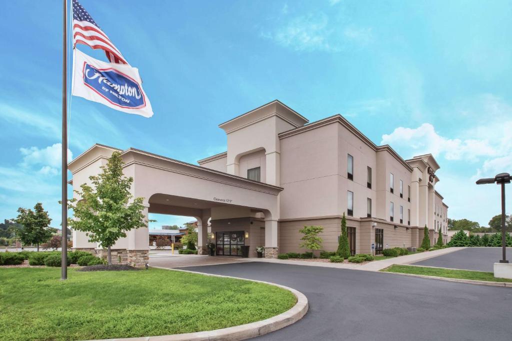 a building with an american flag in front of it at Hampton Inn Brockport in Brockport