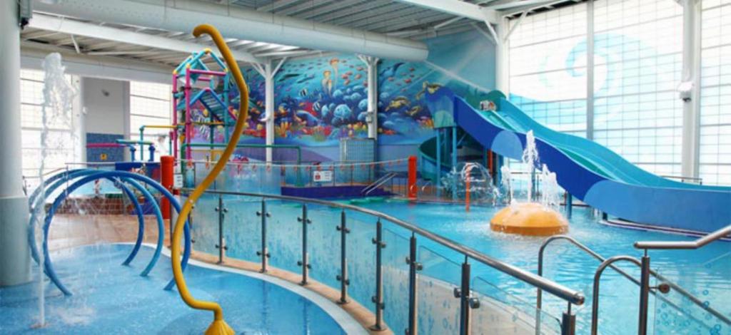 a large indoor water park with a water slide at Blue Dolphin Holiday Park in Gristhorpe