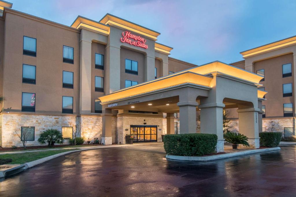 a hotel with a parking lot in front of it at Hampton Inn & Suites Selma-San Antonio/Randolph AFB in Selma