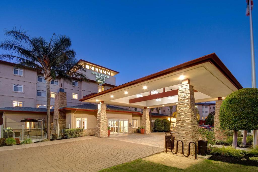 a hotel building with a pavilion with a palm tree at Homewood Suites by Hilton San Francisco Airport North California in Brisbane