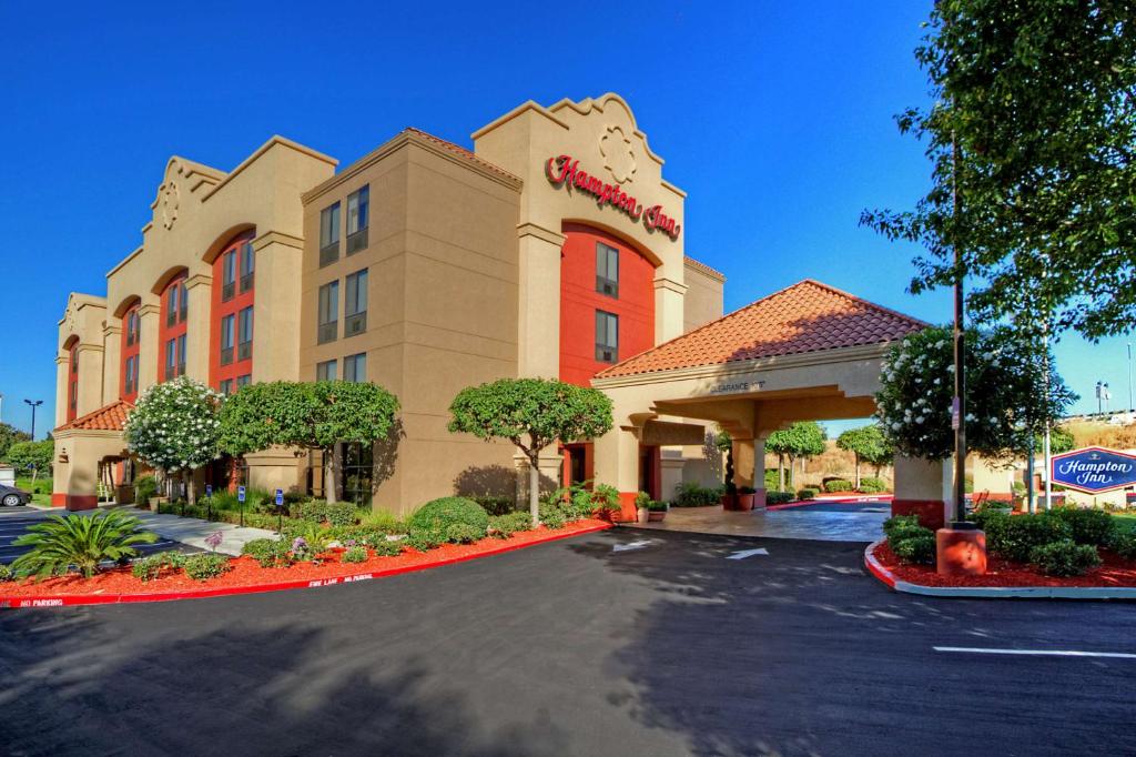 a hotel with a sign on the front of it at Hampton Inn Milpitas in Milpitas