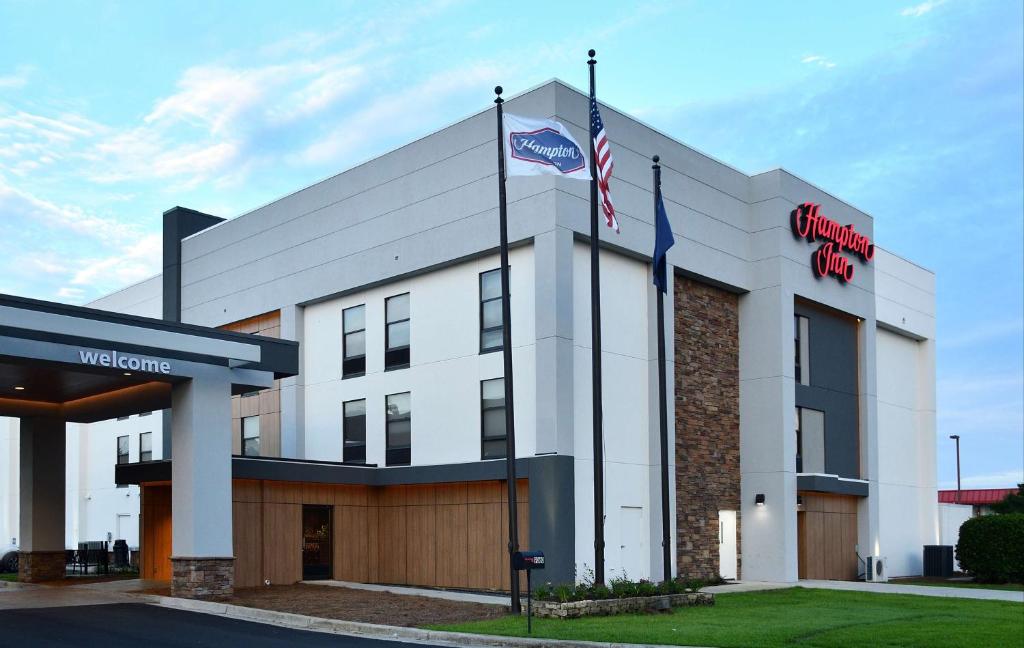a building with two flags in front of it at Hampton Inn Santee-I-95 in Santee